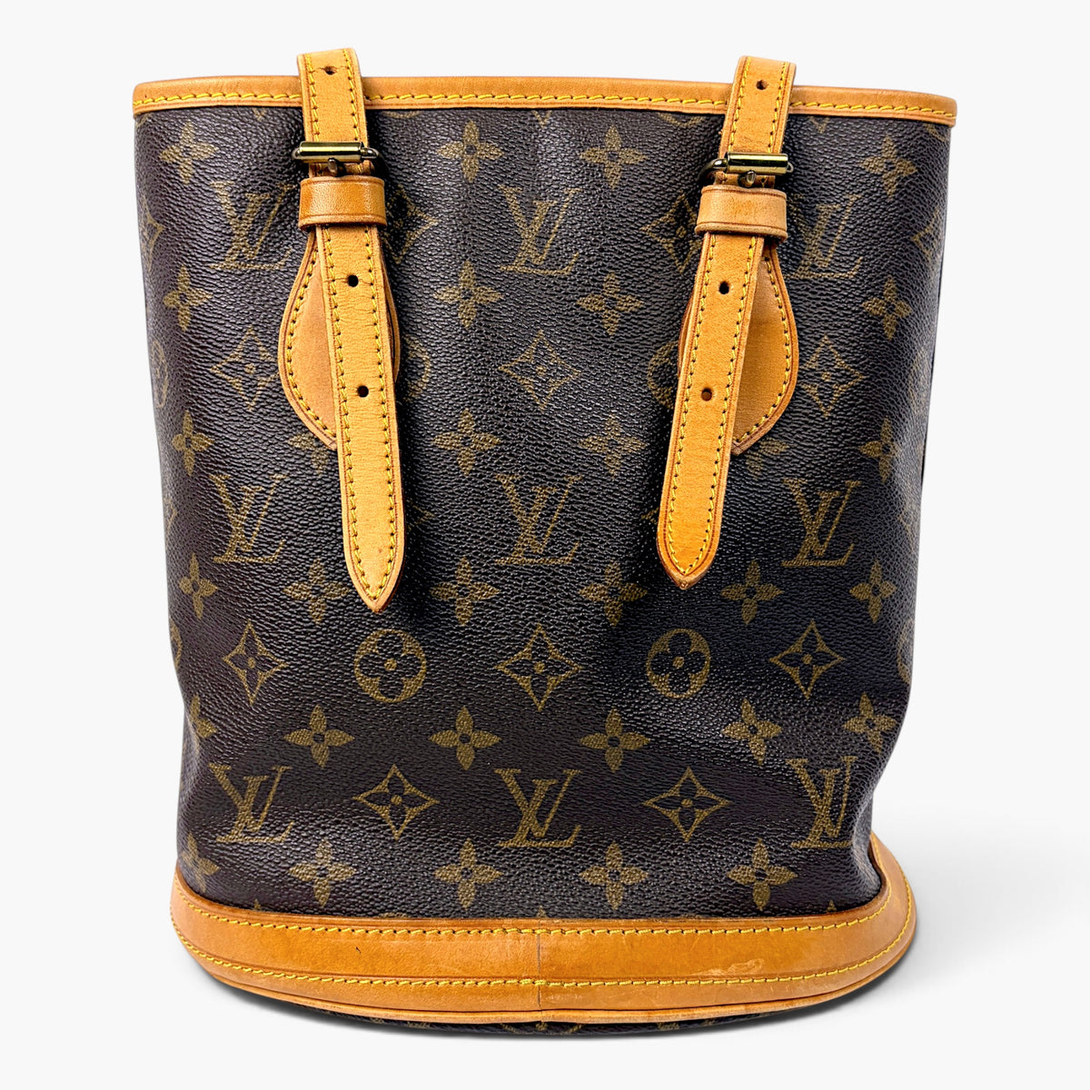 Monogram canvas bucket bag front view with two tan leather handle straps