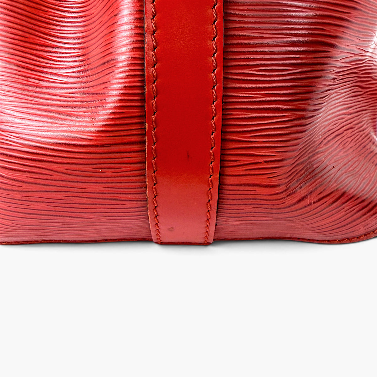 Red bucket bag base with stitched side seam and structured curved shape