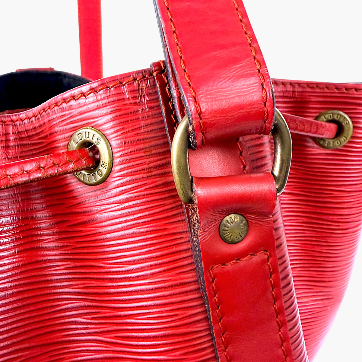 Red bucket bag top with leather strap and antique gold hardware