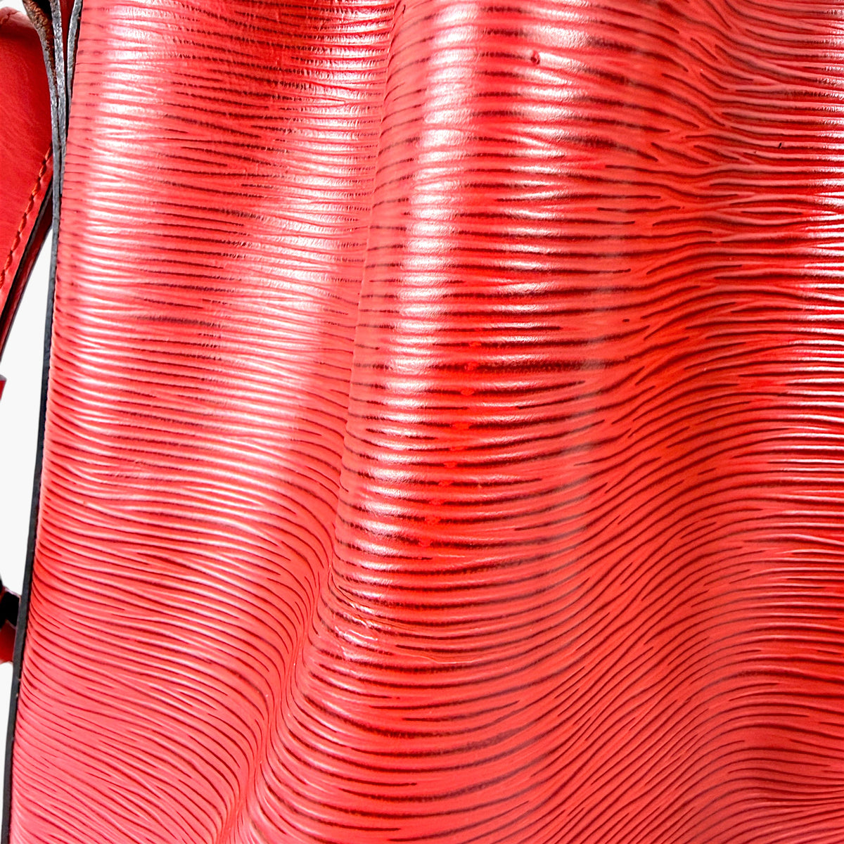 Red textured Epi leather panel with wavy embossed lines