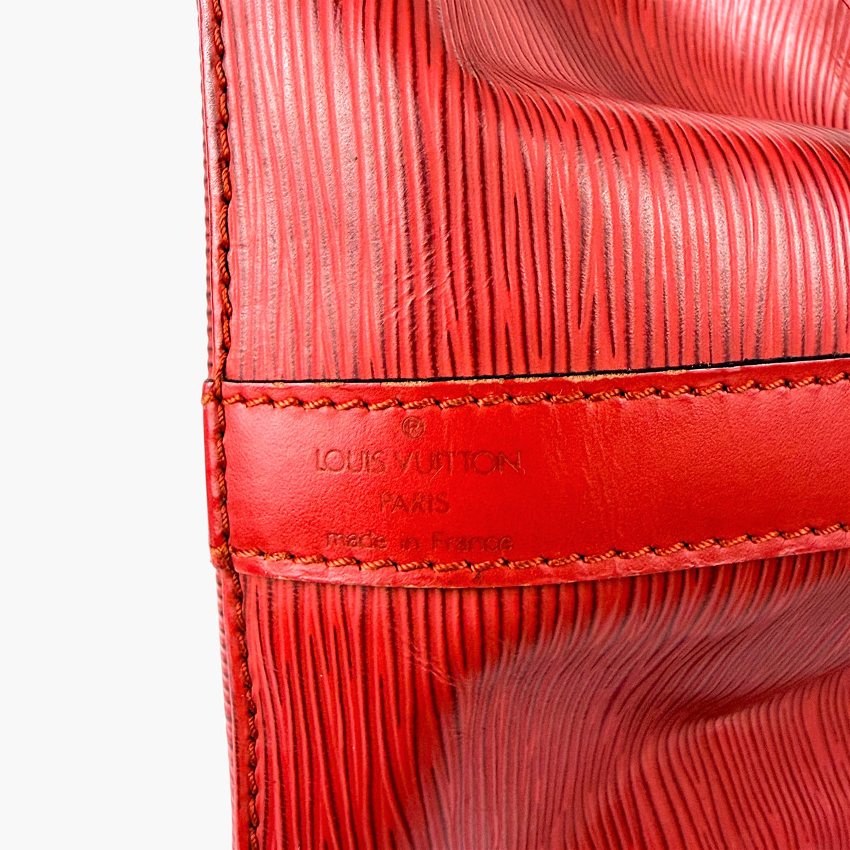 Red bucket bag interior panel with LOUIS VUITTON PARIS stamp