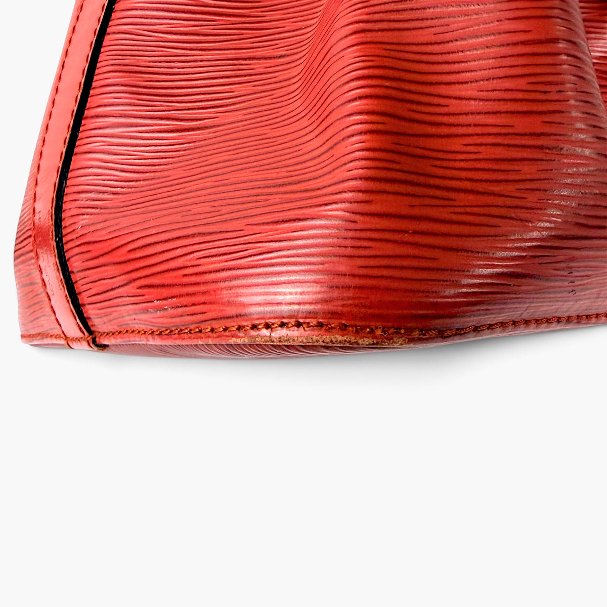 Red Epi leather base edge with black trim piping and stitched seam