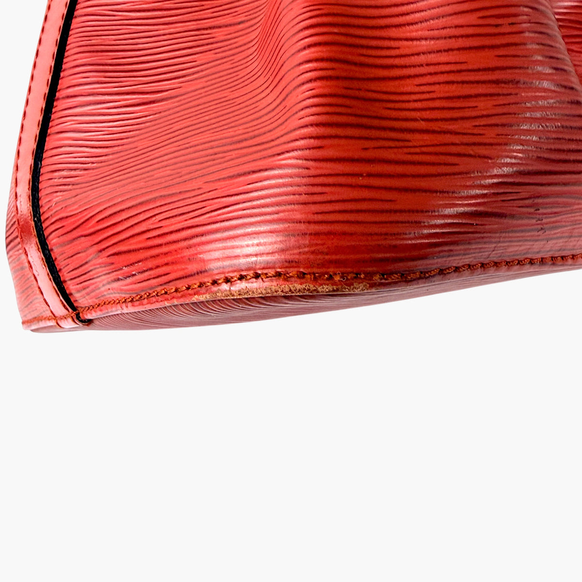 Red Epi leather side with brownish edge piping and stitched hem