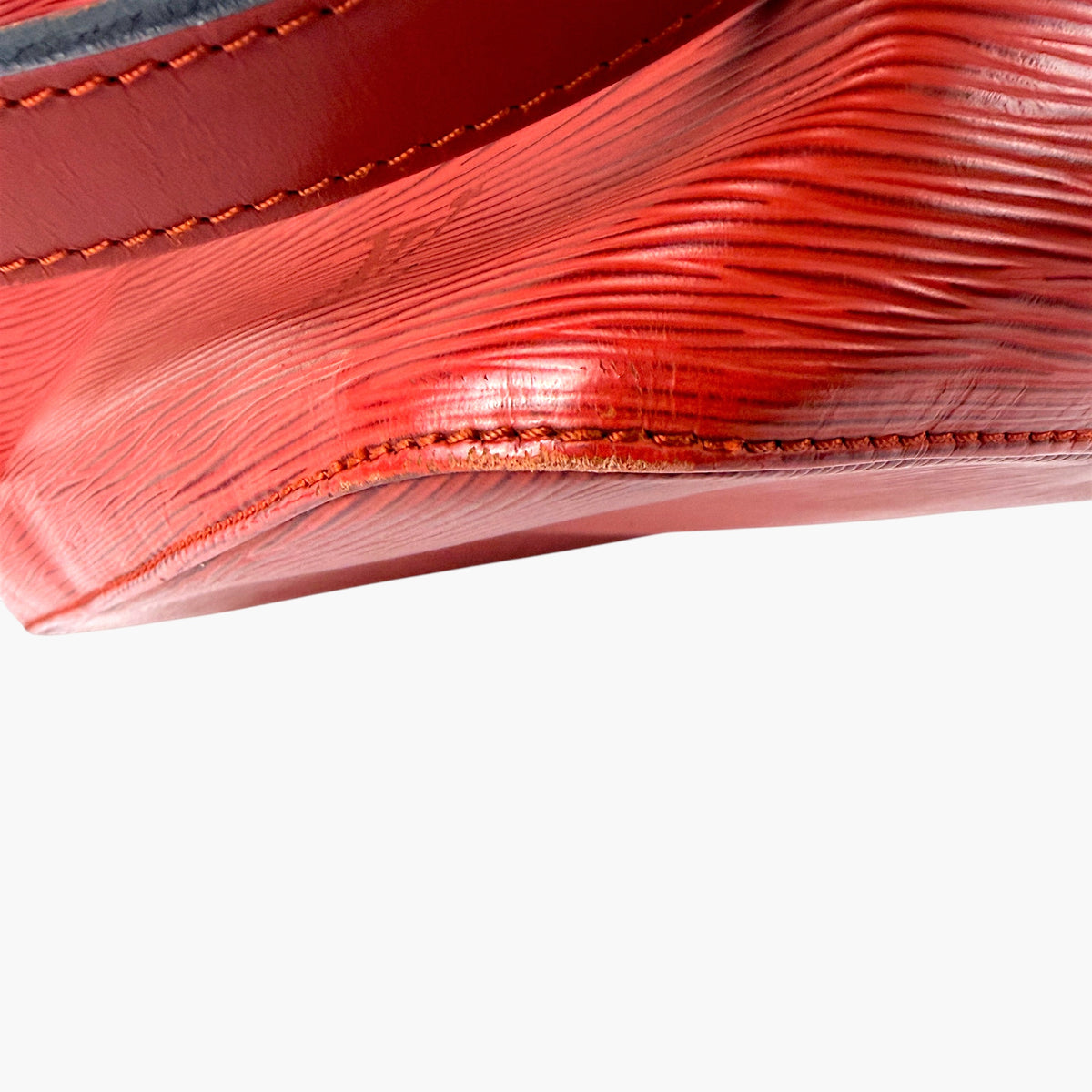 Red Epi leather corner with topstitching along base edge
