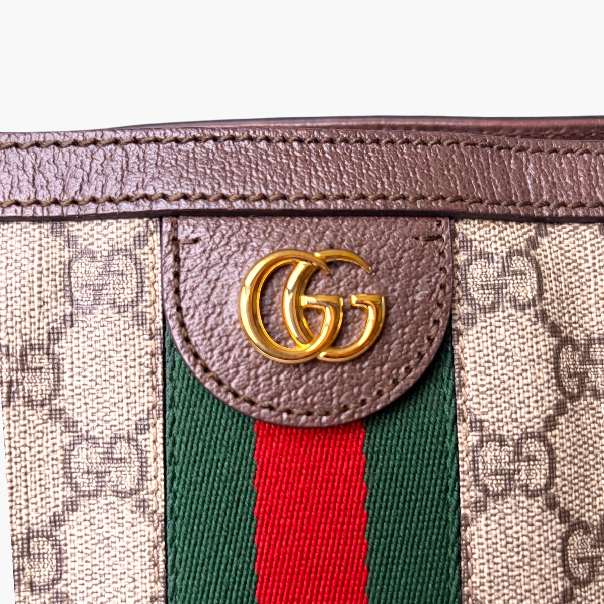 Beige GG monogram tote front with brown leather flap and GG gold logo detail