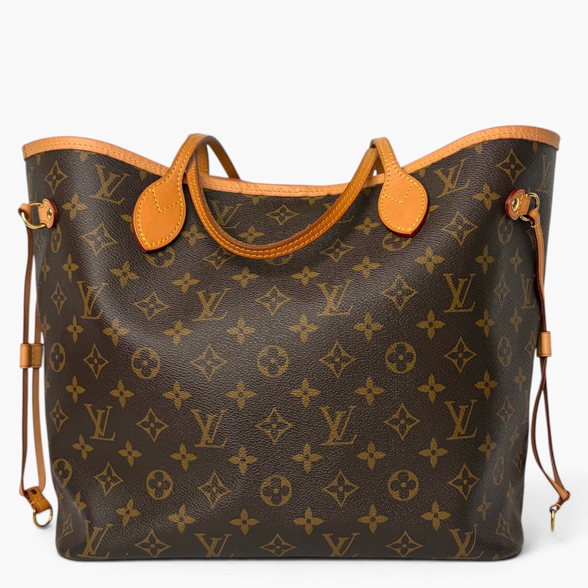 Monogram tote bag with tan leather handles and adjustable shoulder straps