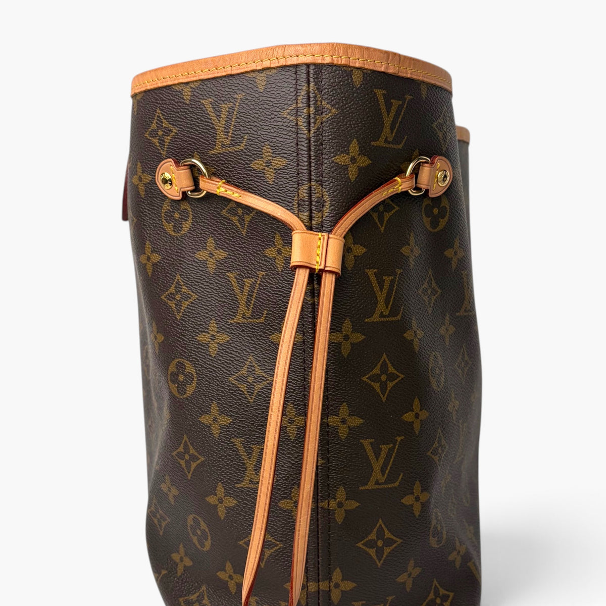 Monogram tote bag with tan leather drawstring and gold-tone hardware front view