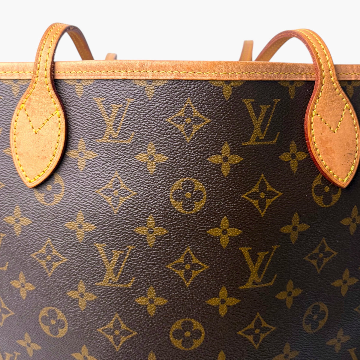 Brown monogram canvas tote bag with tan leather trim and two top handles