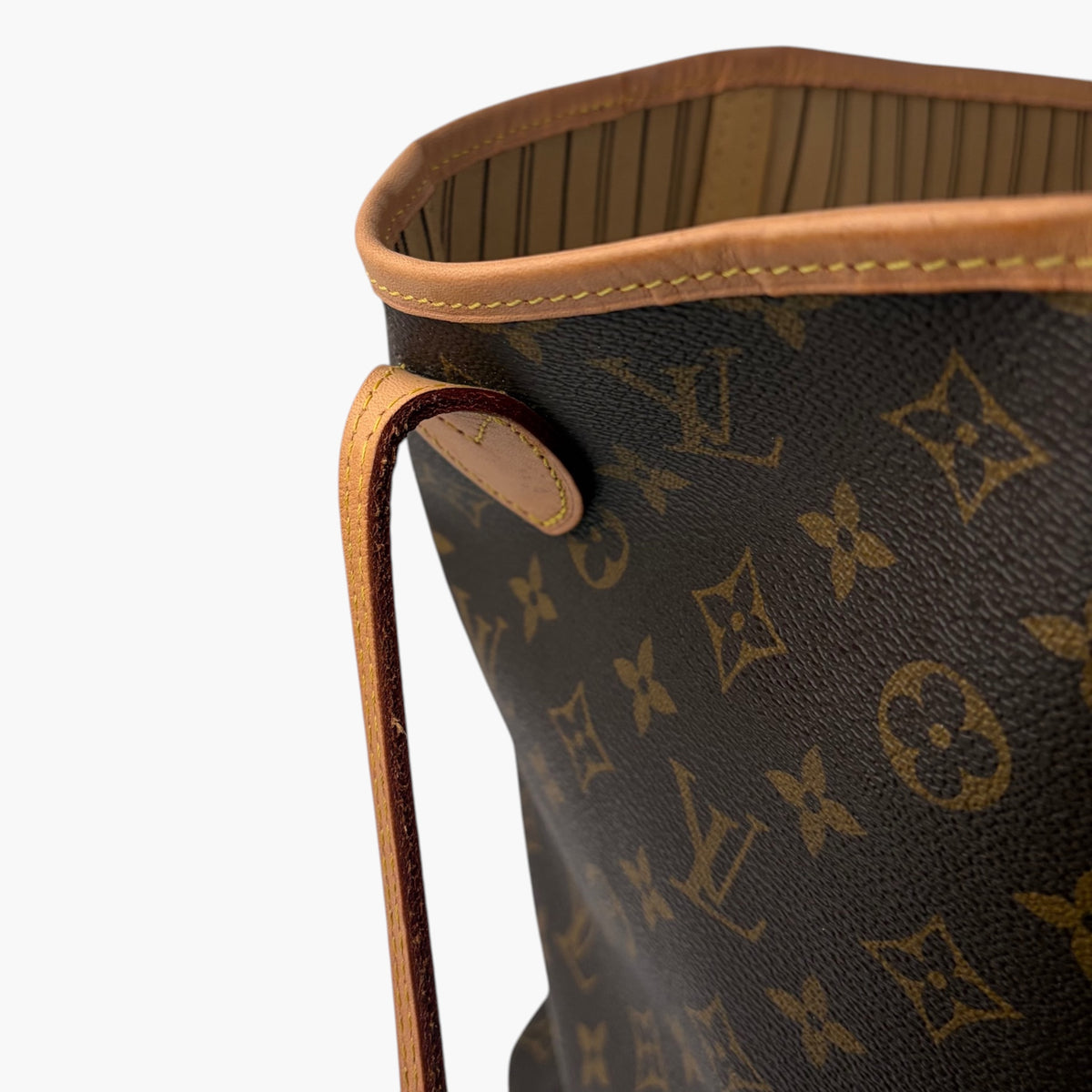 Brown monogram tote bag interior view with tan trim and striped lining
