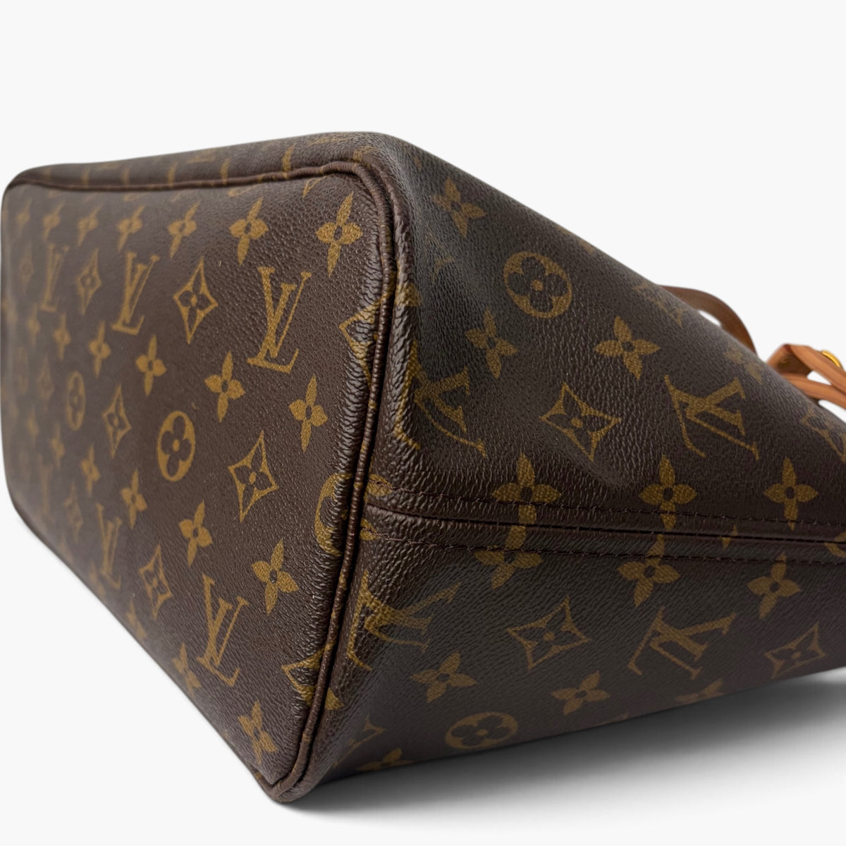 Brown monogram canvas pouch corner with smooth leather trim and top stitching