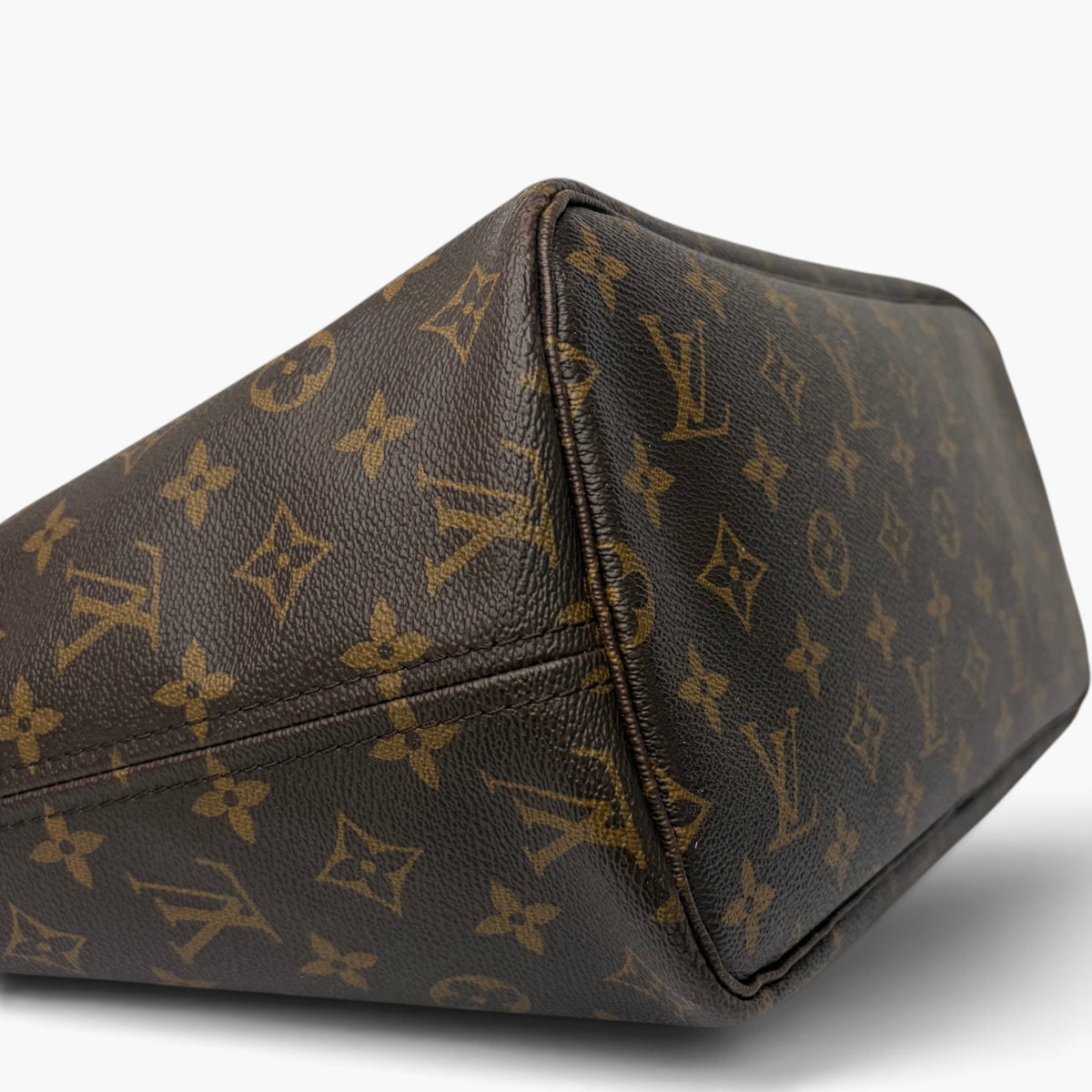 Brown monogram canvas pouch with stitched corner seam and leather edging