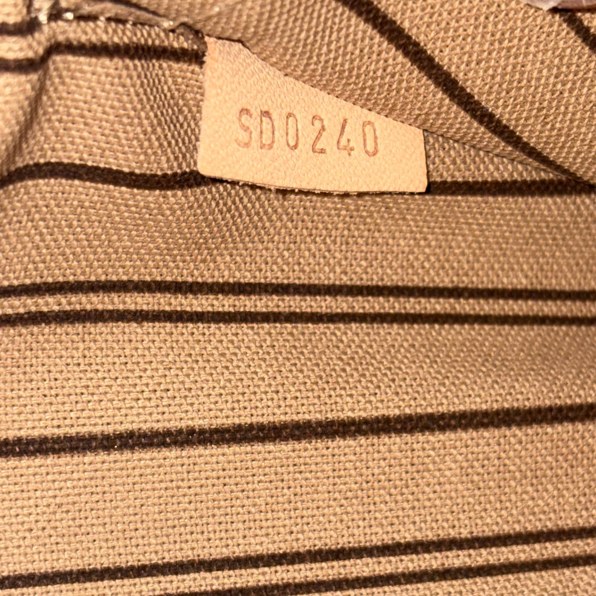 Fabric tag with date or code marking on monogram canvas lining