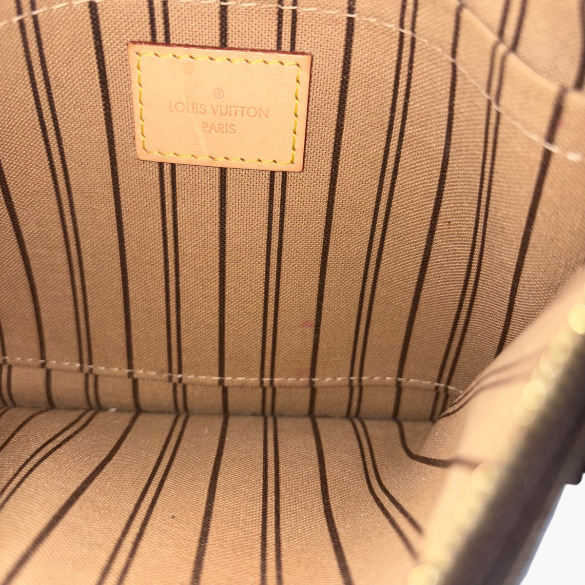 Fabric lining inside with Louis Vuitton Paris logo patch and stitched paneling