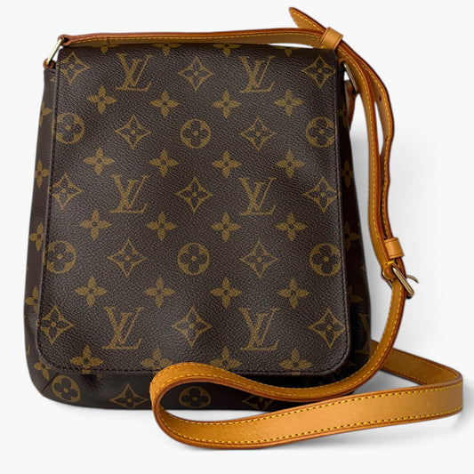 Monogram crossbody bag with long strap, dark canvas exterior and tan trim details
