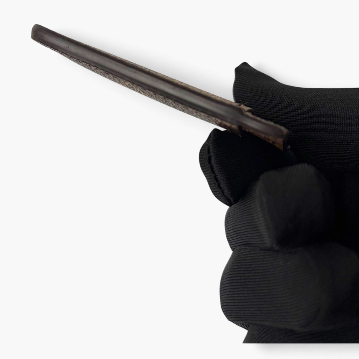 Monogram card holder side view showing thickness and dark brown edge