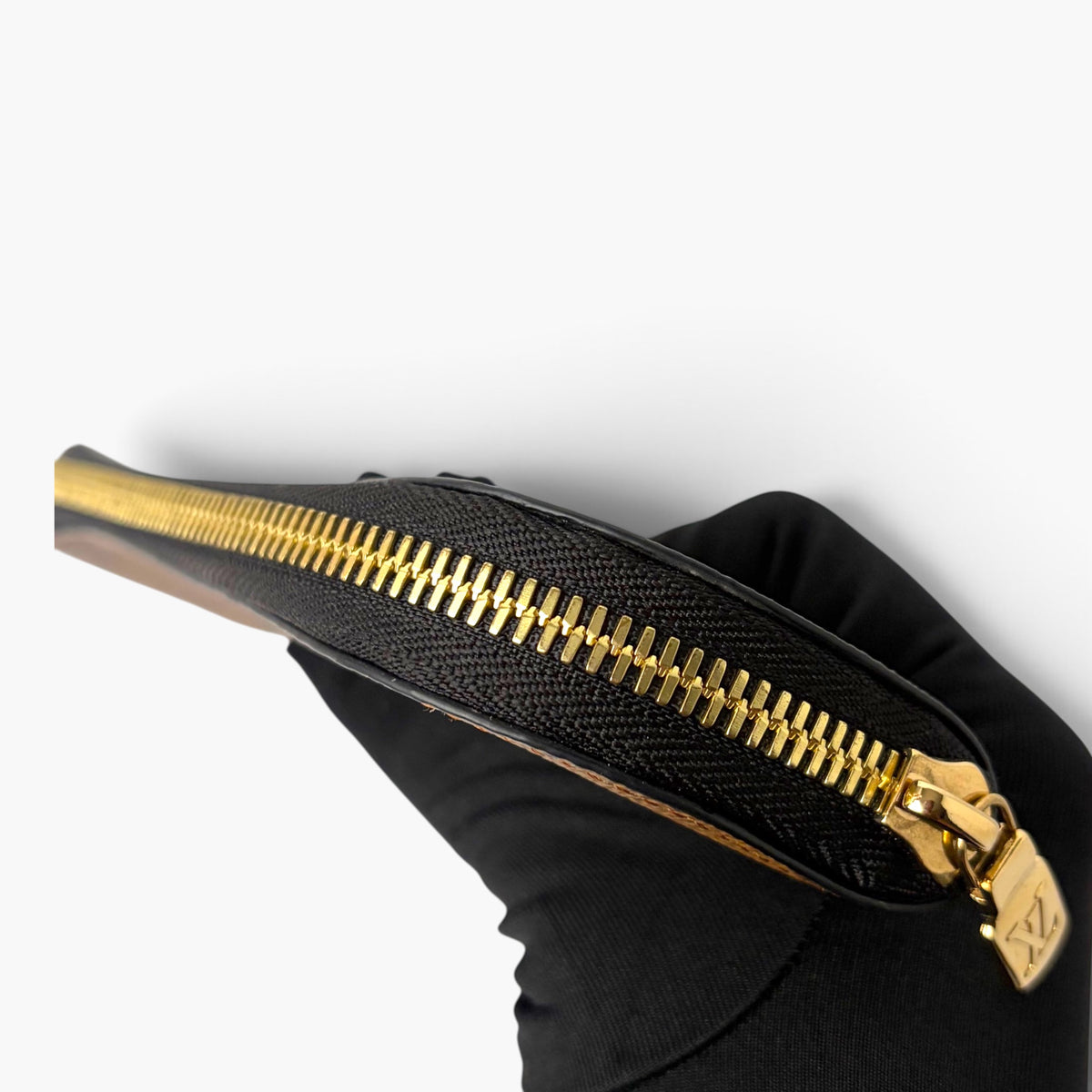 Black monogram-look pencil case with gold zipper and gold-tone pull tab