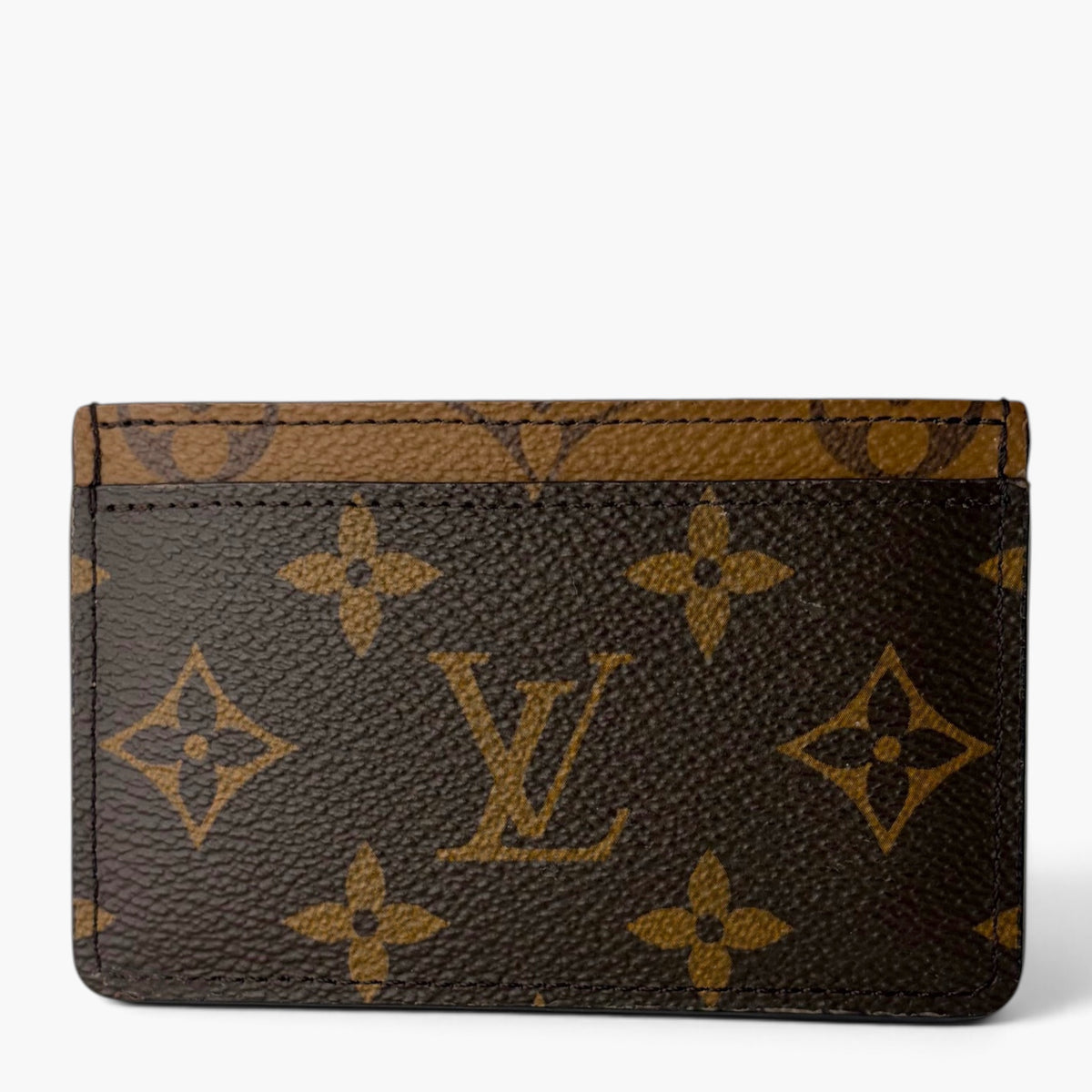 Dark-brown monogram card holder with stitched trim and repeating logo pattern