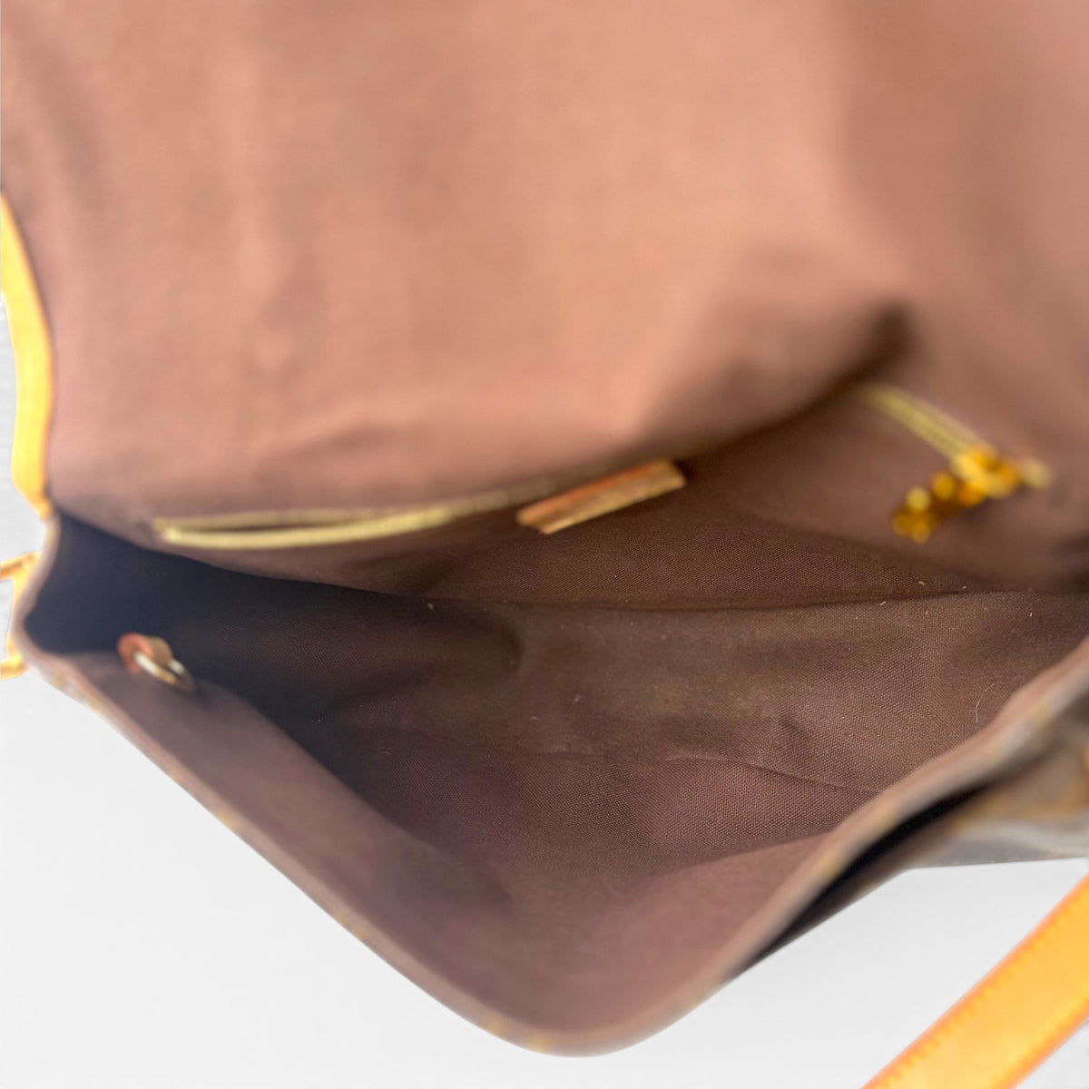 Mini bag interior with brown lining and leather edge at the top opening