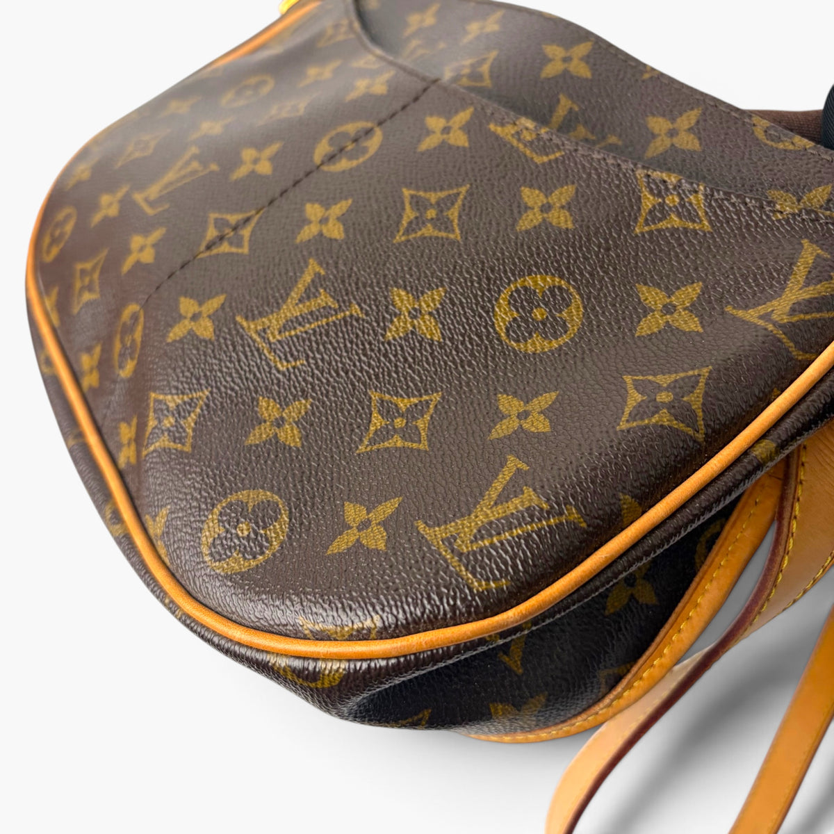 Brown monogram-pattern crossbody bag with tan trim and adjustable strap