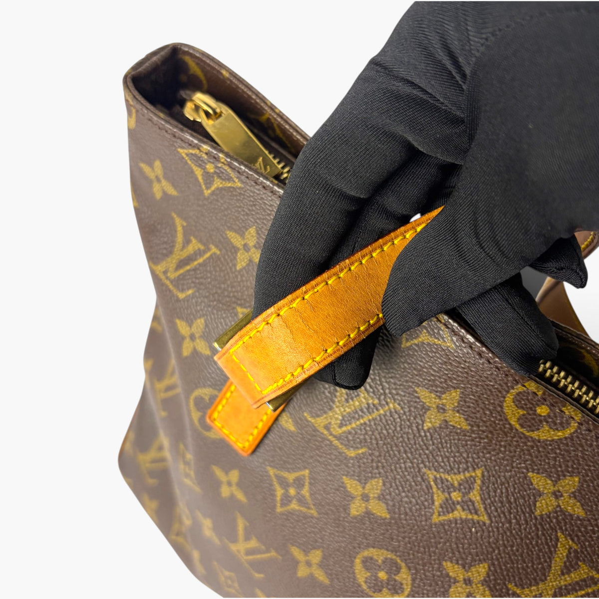 Monogram canvas tote with dark fabric handle, orange trim and gold-tone zipper