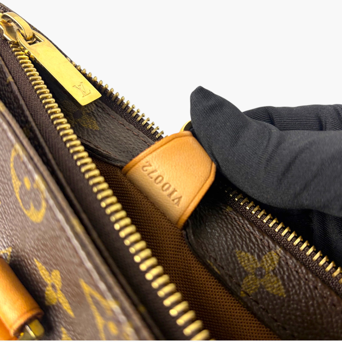 Monogram canvas tote with gold zipper and orange leather zipper pull