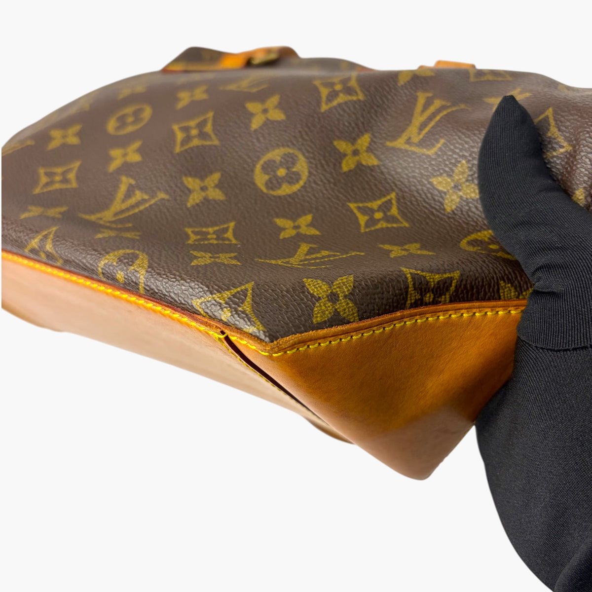 Brown monogram canvas tote with tan leather trim and curved top edge