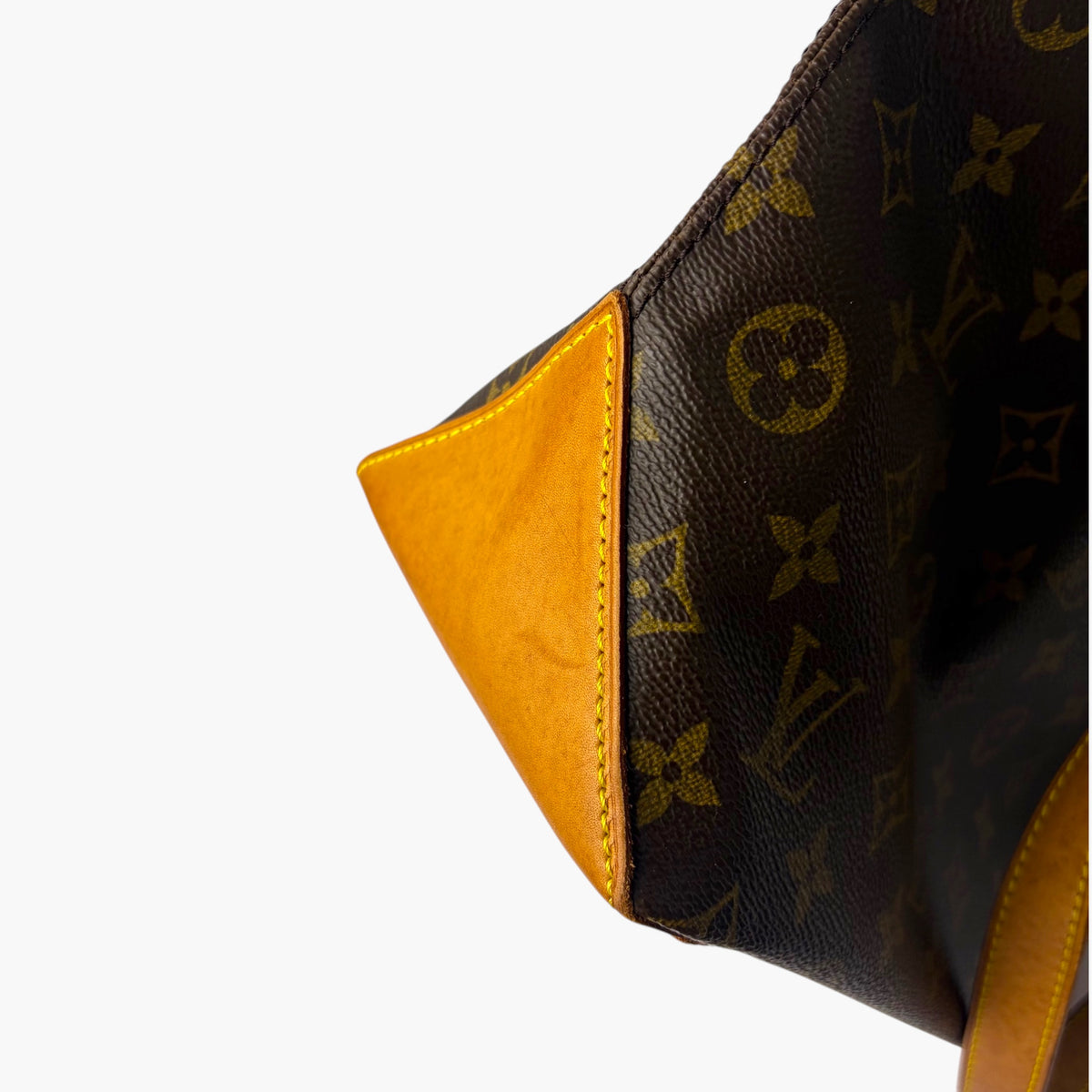 Brown monogram canvas corner with tan leather trim and curved side seam