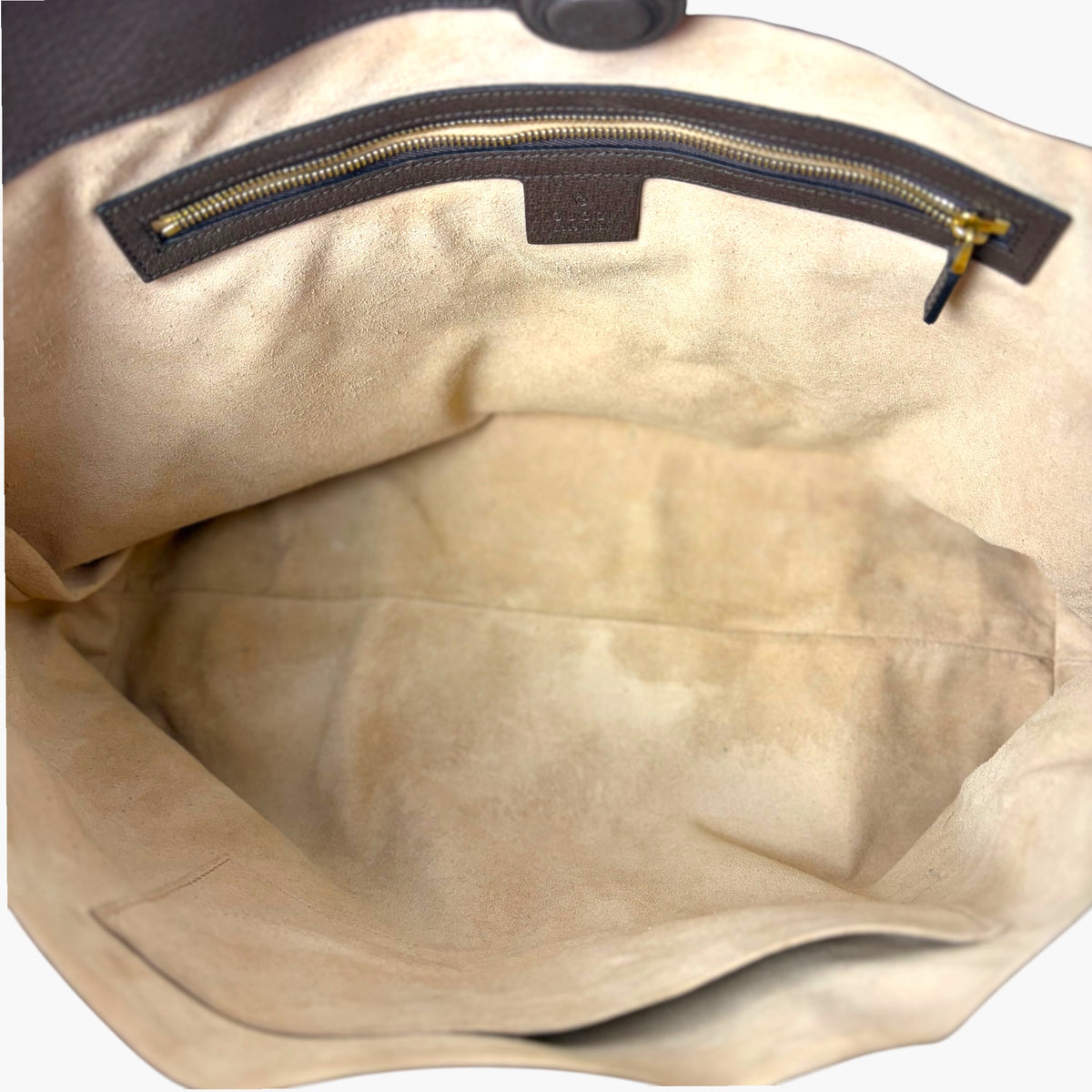 Medium tote interior with beige fabric lining and top zipper opening