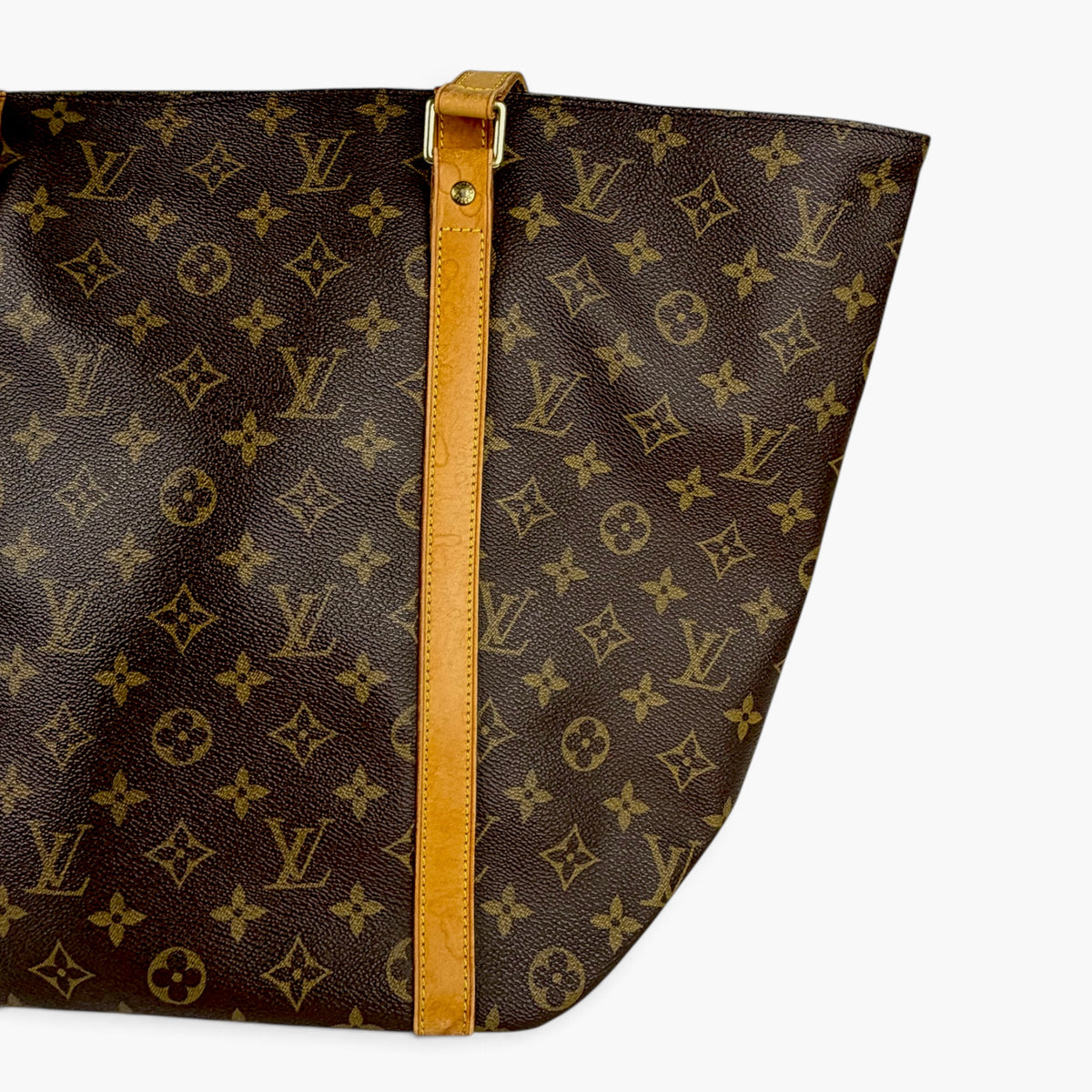Brown monogram tote bag interior opening with tan center strap