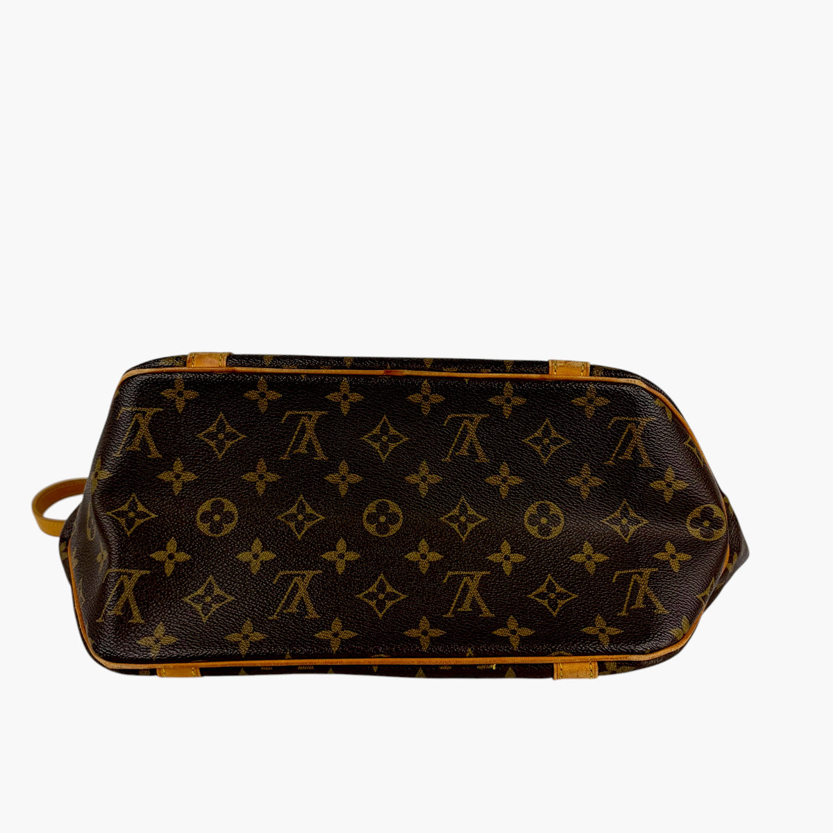 Monogram tote bag with dark base, tan trim, and shoulder strap loops