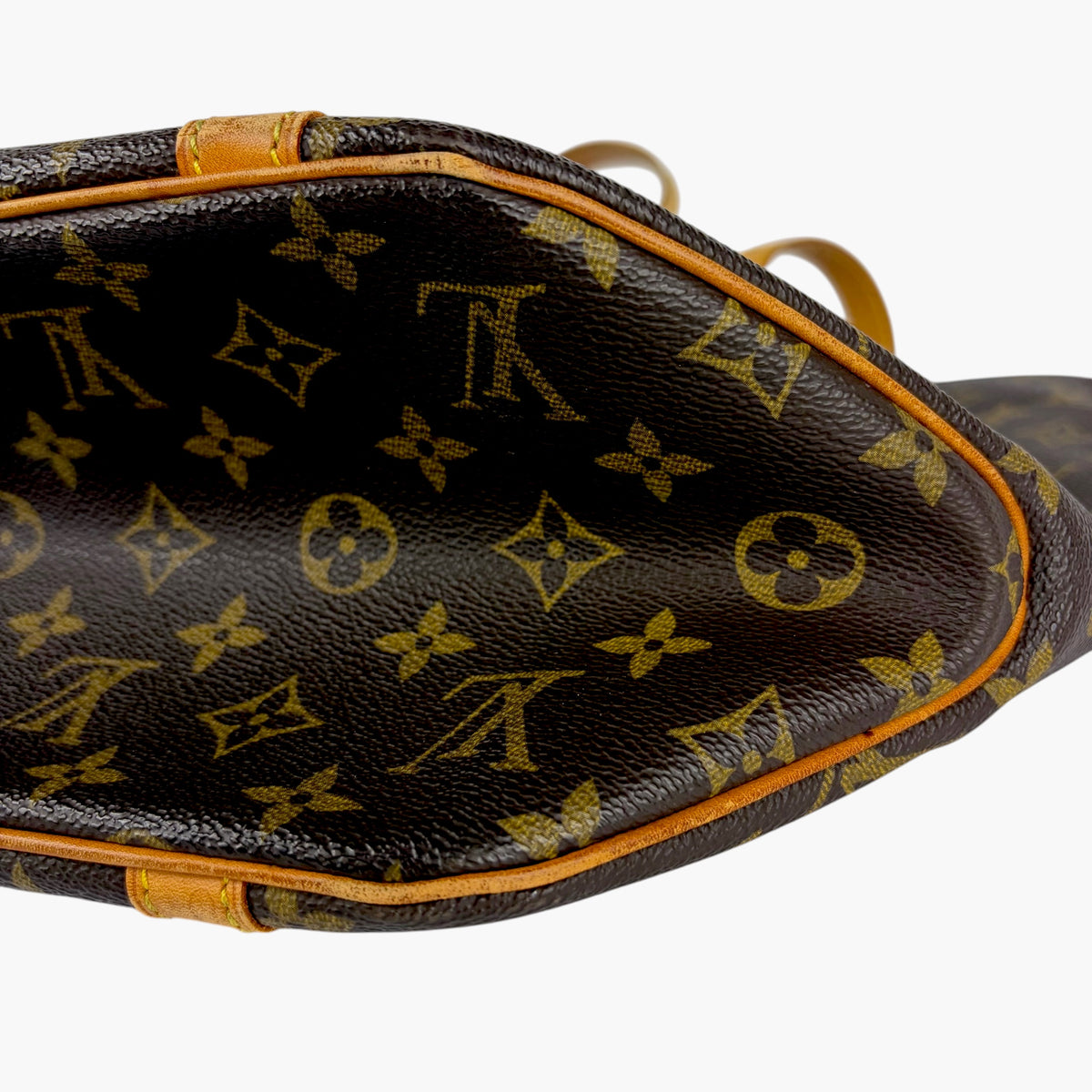 Brown monogram shopping tote bag with tan trim and visible top opening edge
