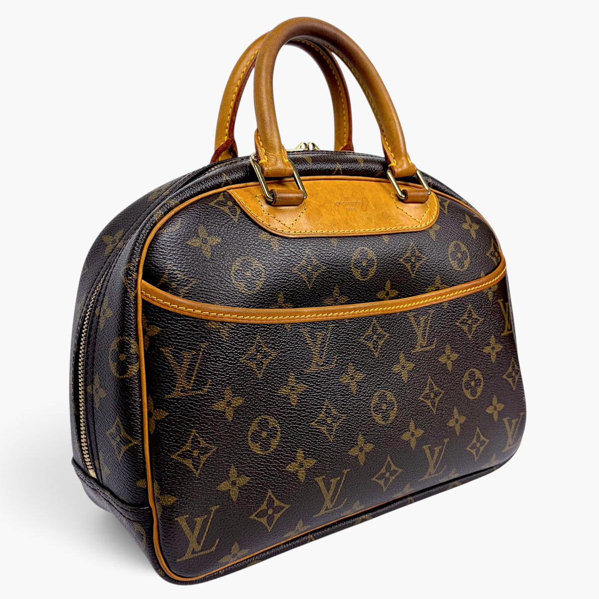 Brown monogram canvas handbag with tan leather handles and curved top silhouette