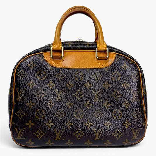 Monogrammed top-handle bag with tan leather handles and gold-tone hardware