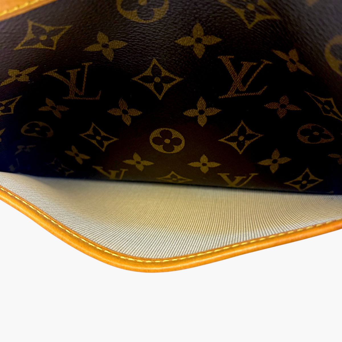 Brown monogram bag corner with orange piping and cream lining