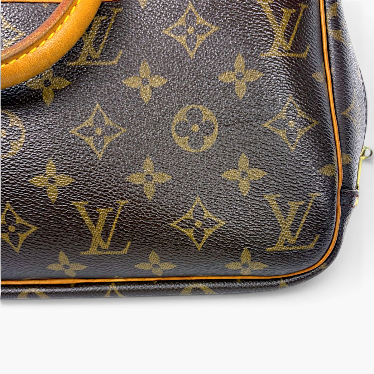 Brown monogram leather exterior panel with orange edge trim