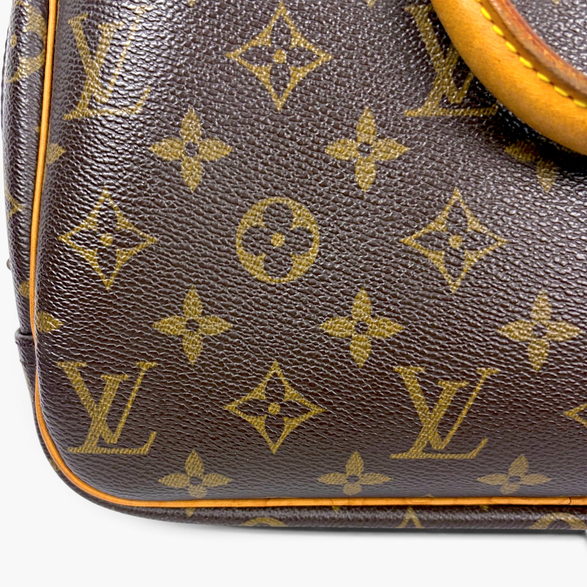 Brown monogram leather base with orange trim and curved edge