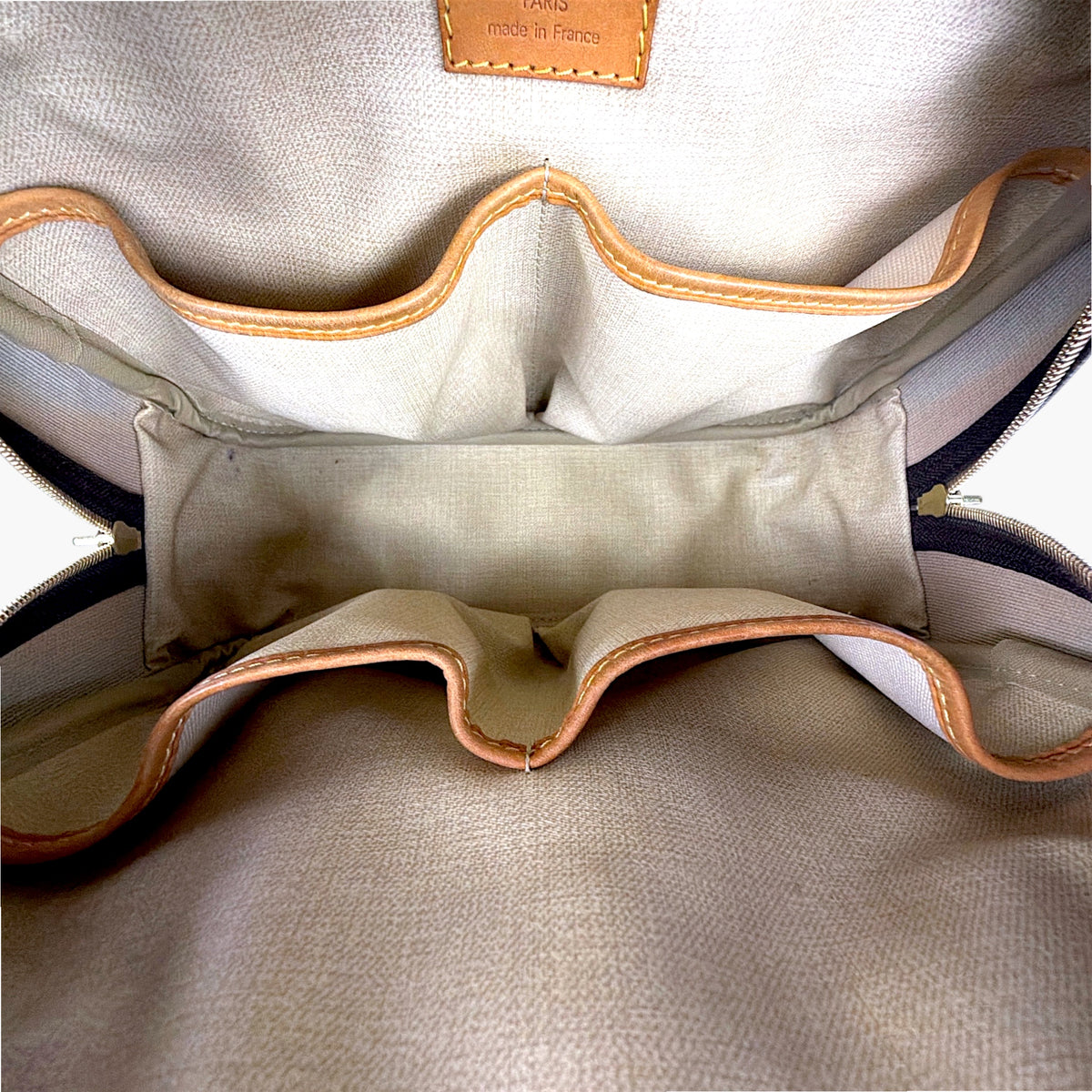 Leather monogram bag interior with tan lining and drawstring loops