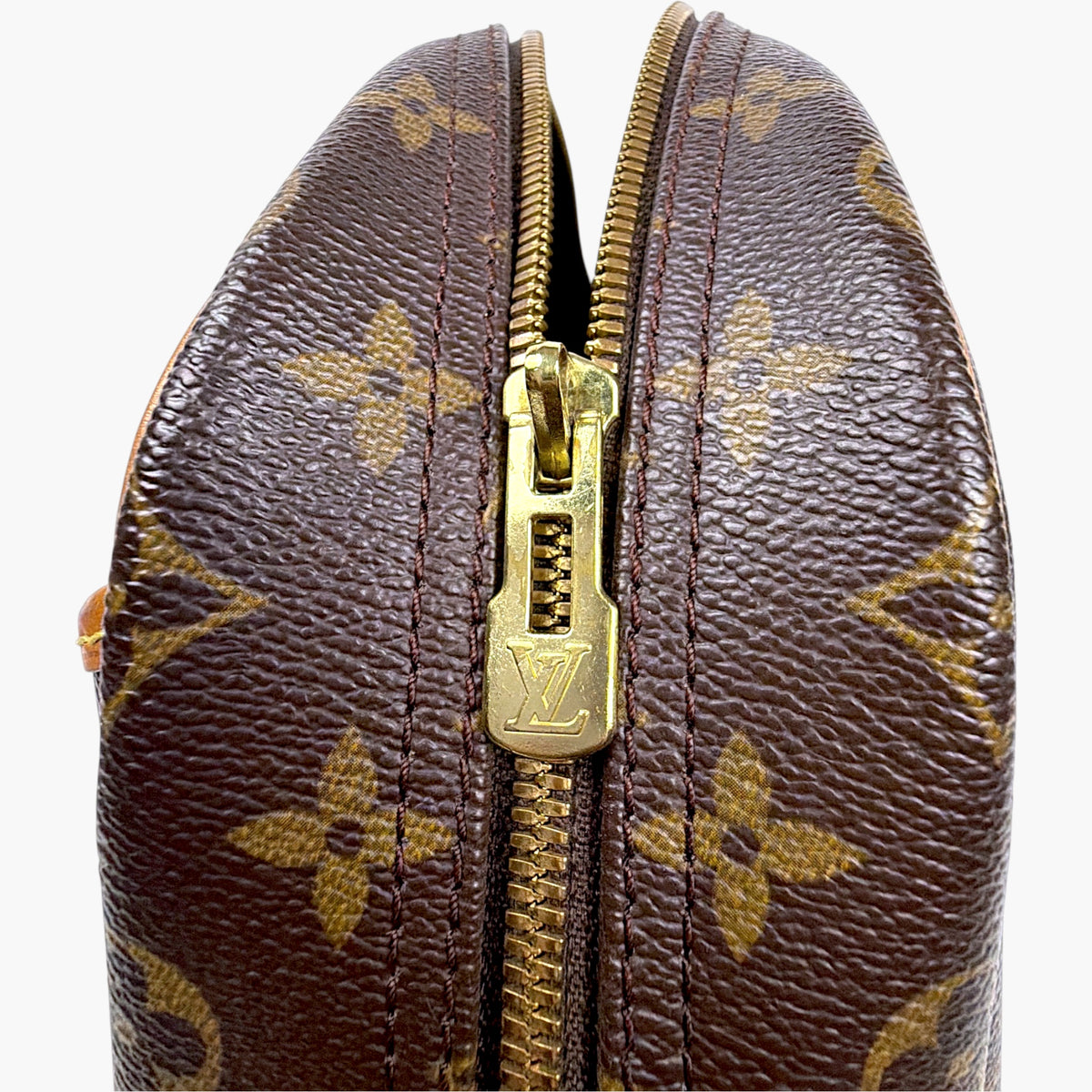 Brown monogram bag top zipper with gold-tone hardware and pull tab